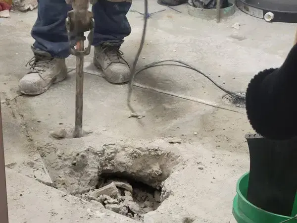 Concrete slab opened with a breaker to reach a leaking pipe in a Largo home